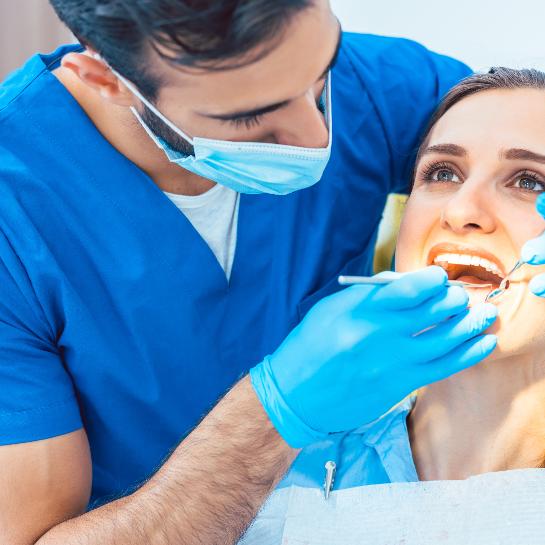 A dentist doing dental check up on a woman